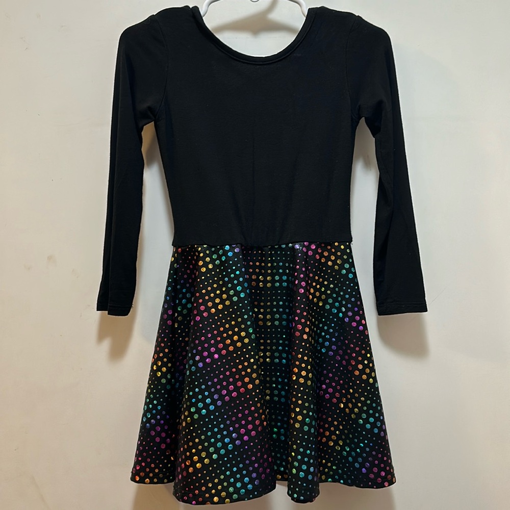 Pixie lane dress has black on top and flared rainbow sparkle on bottom. Size 2/3